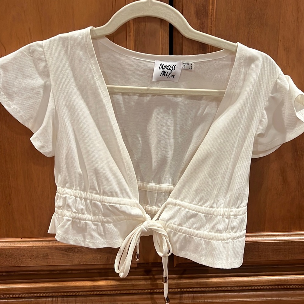 Cream cropped top, low cut, ties in the front